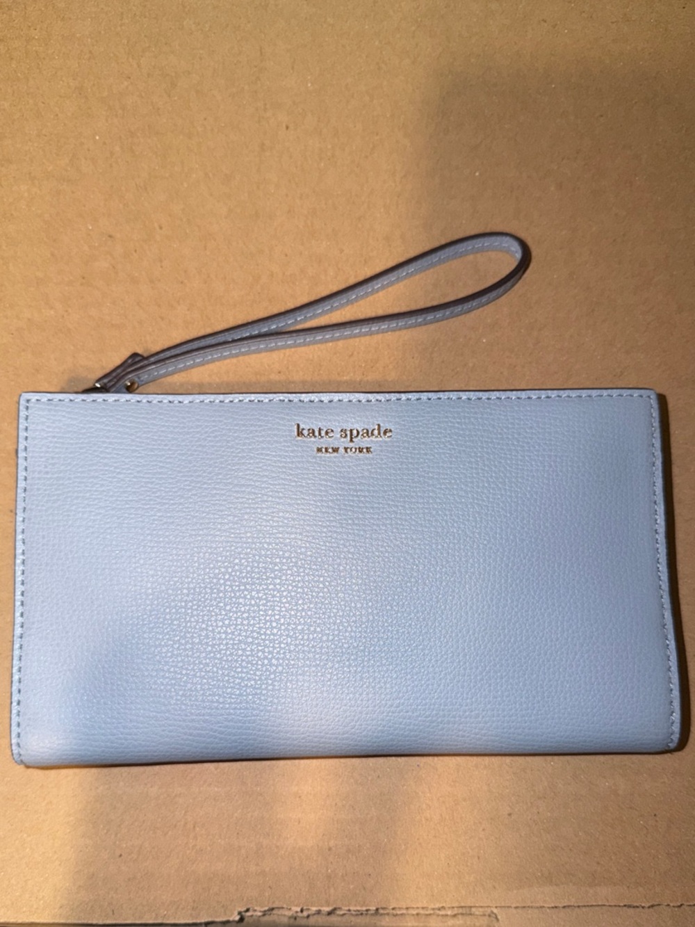 kate spade baby blue leather wristlet with gold logo